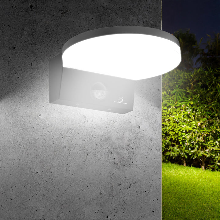 Maclean MCE344 B motion sensor LED lamp. Featuring a PIR motion sensor, it emits a neutral white light (4000K) with 15W power and 1560lm brightness. Rated IP65, it ensures durability and reliability in various settings.